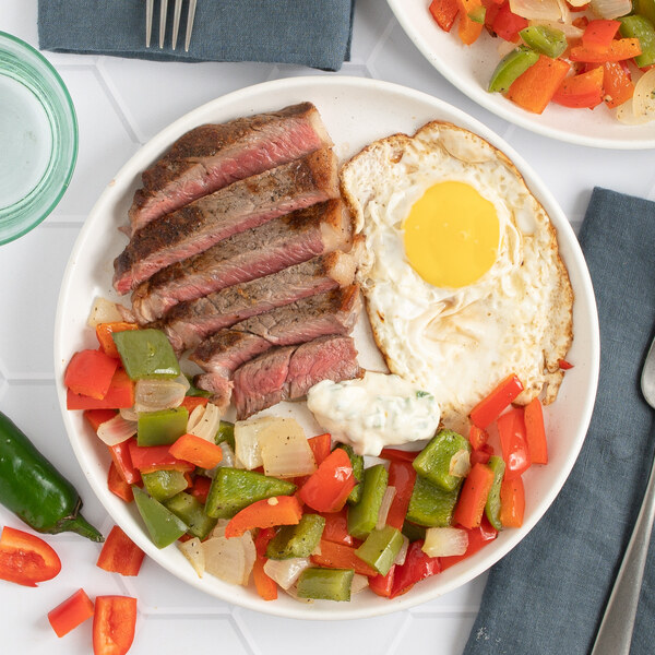 Strip Steak with Fried Egg, Bell Pepper-Onion Medley & Jalapeño Aioli